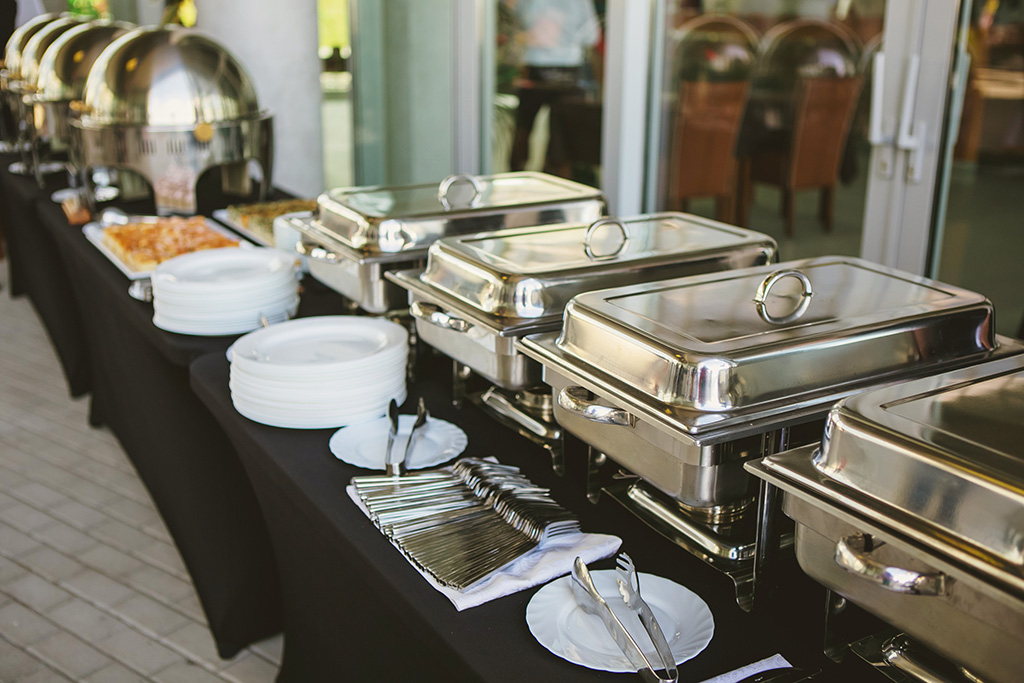 A buffet line with many pans and dishes